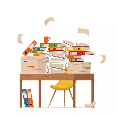 table envahie par une pile de papiers, classeurs et dossiers